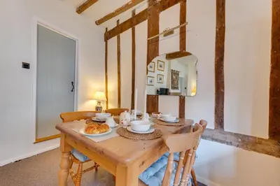 a dining room with a wooden table and chairs at 2 Bed in Lavenham oc-24ss in Lavenham