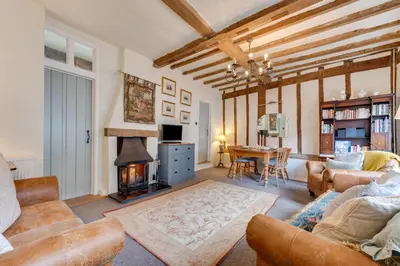 a living room with a couch and a fireplace at 2 Bed in Lavenham oc-24ss in Lavenham