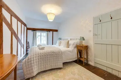 a bedroom with a bed and a table and a window at 2 Bed in Lavenham oc-24ss in Lavenham