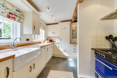 a kitchen with white cabinets and a sink at 2 Bed in Lavenham oc-24ss in Lavenham