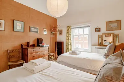 a bedroom with two beds and a mirror at 4 Bed in Aldeburgh oc-sfcrr in Aldeburgh