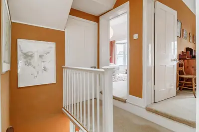 a hallway with orange walls and a white door at 4 Bed in Aldeburgh oc-sfcrr in Aldeburgh