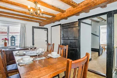 a dining room with a wooden table and chairs at 2 Bed in Aldeburgh oc-sfdar in Aldeburgh