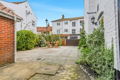 a courtyard of a house with a brick wall at 2 Bed in Aldeburgh oc-sfdar in Aldeburgh