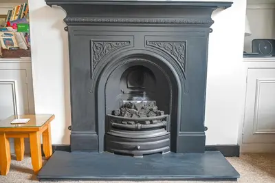 a black fireplace in a living room at 2 Bed in Aldeburgh oc-sfdar in Aldeburgh