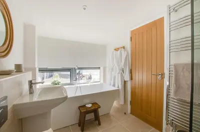 a white bathroom with a sink and a shower at 2 Bed in Woodbridge oc-chand in Woodbridge