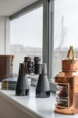 a pair of binoculars sitting on a counter next to a window at 2 Bed in Woodbridge oc-chand in Woodbridge