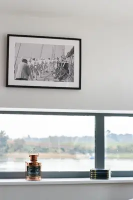 a framed photograph of a group of people on a boat in a window at 2 Bed in Woodbridge oc-chand in Woodbridge