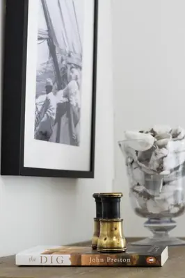 a book on a table with a picture and a bottle at 2 Bed in Woodbridge oc-chand in Woodbridge