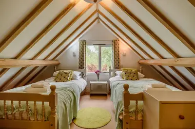two beds in a attic bedroom with a roof at 2 Bed in Rumburgh oc-dgf in Rumburgh