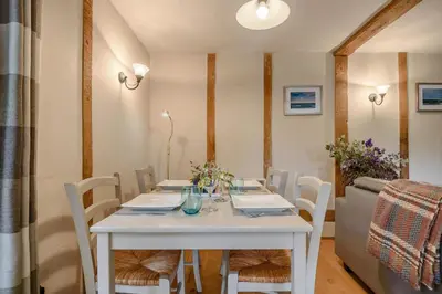 a white table with white chairs and a white table sidx sidx sidx at 2 Bed in Rumburgh oc-dgf in Rumburgh