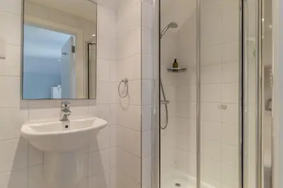 a white bathroom with a sink and a shower at 3 Bed in Knodishall oc-ebco in Aldringham