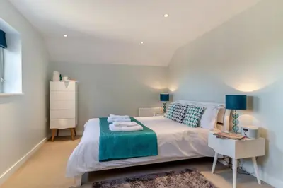 a bedroom with a white bed with towels on it at 3 Bed in Knodishall oc-ebco in Aldringham