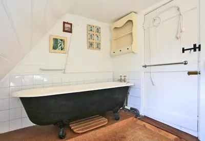 a bathroom with a black bath tub in a room at 3 Bed in Hemley oc-g91 in Hemley