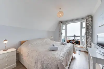 a bedroom with a bed and a large window at 3 Bed in Felixstowe oc-fel in Felixstowe
