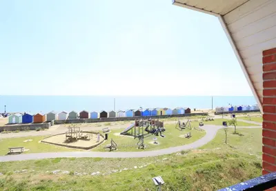 a view of a playground with the ocean in the background at 3 Bed in Felixstowe oc-fel in Felixstowe