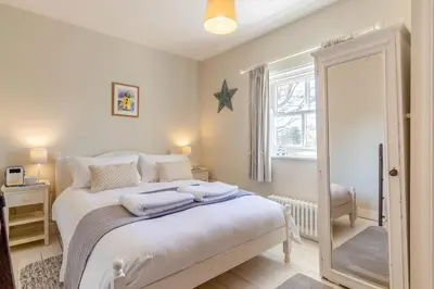 a bedroom with a bed with towels on it at 2 Bed in Aldeburgh oc-fsh in Aldeburgh
