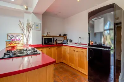 a kitchen with a red counter top and a black refrigerator at 2 Bed in Aldeburgh oc-fsh in Aldeburgh