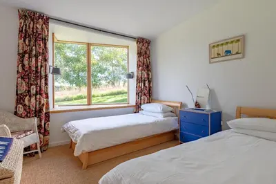 a bedroom with two beds and a window at 3 Bed in Bramfield oc-hglenv in Bramfield