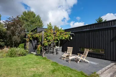 a patio with two chairs and a pergola at 3 Bed in Bramfield oc-hglenv in Bramfield