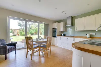 a kitchen with a table and chairs and a dining room at 4 Bed in Hacheston oc-hac in Marlesford