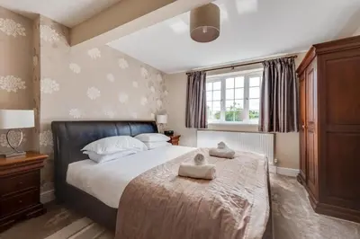 a bedroom with a bed with two towels on it at 4 Bed in Hacheston oc-hac in Marlesford