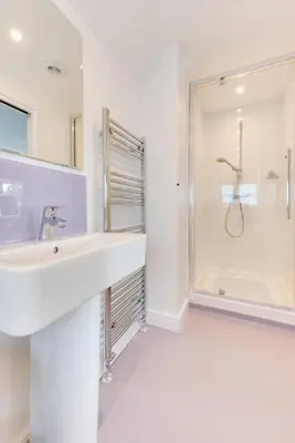 a white bathroom with a sink and a shower at 4 Bed in Hacheston oc-hac in Marlesford