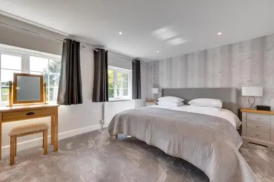 a bedroom with a bed and a desk and a television at 4 Bed in Hacheston oc-hac in Marlesford