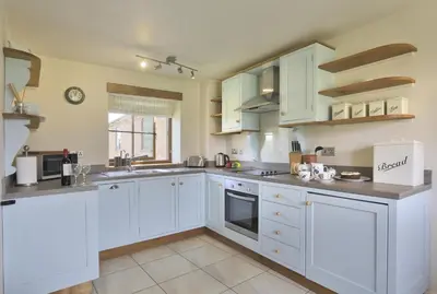 a white kitchen with white cabinets and appliances at 2 Bed in Yoxford oc-hharro in Yoxford