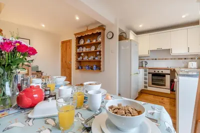 a kitchen with a table with a bowl of food on it at 3 Bed in Middleton oc-htv in Middleton