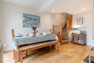 a dining room with a table with dishes on it at 3 Bed in Middleton oc-htv in Middleton
