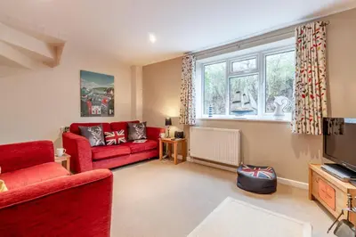 a living room with a red couch and a tv at 3 Bed in Middleton oc-htv in Middleton