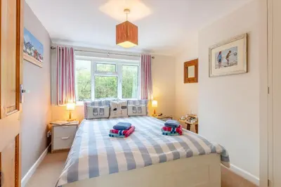 a bedroom with a large bed with two pillows on it at 3 Bed in Middleton oc-htv in Middleton