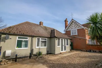 a house with a palm tree in front of it at 2 Bed in Felixstowe oc-hideo in Felixstowe