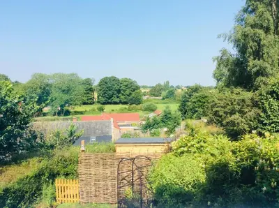 a view of a garden with trees and buildings at 2 Bed in Halesworth oc-rect in Halesworth
