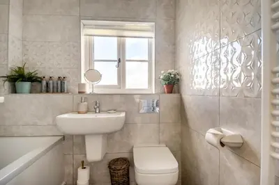 a bathroom with a sink and a toilet and a window at 2 Bed in Halesworth oc-rect in Halesworth