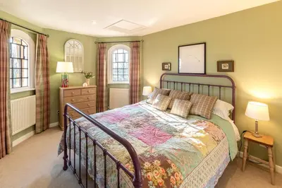 a bedroom with a bed and two windows at 2 Bed in Tunstall oc-ivylod in Rendlesham