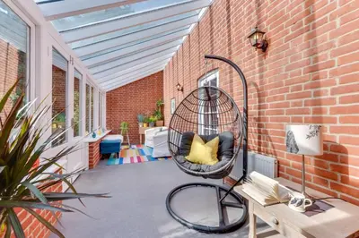 a porch with a bird cage sitting on a brick wall at 2 Bed in Tunstall oc-ivylod in Rendlesham