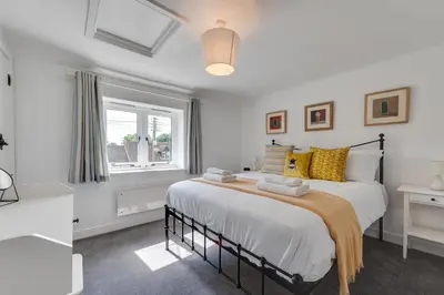 a bedroom with a large bed and a window at 1 Bed in Wenhaston oc-jap in Wenhaston