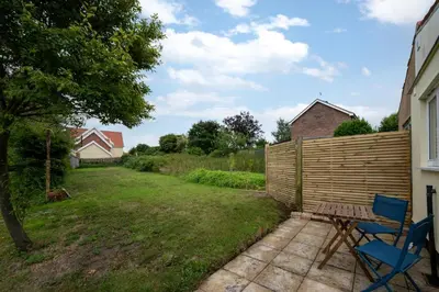 a yard with a fence and a blue chair at 1 Bed in Wenhaston oc-jap in Wenhaston