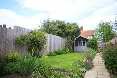 a backyard with a fence and a garden at 2 Bed in Orford oc-sflis in Orford