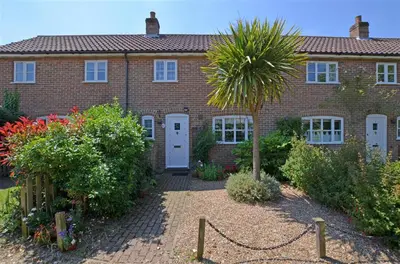 a brick house with a palm tree in front of it at 2 Bed in Friston oc-lcq in Friston