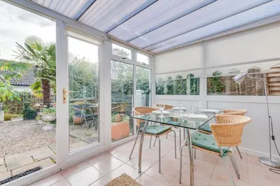 a dining room with a glass table and chairs at 2 Bed in Friston oc-lcq in Friston