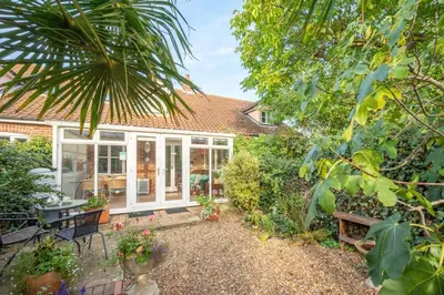 a home with a conservatory and a garden at 2 Bed in Friston oc-lcq in Friston