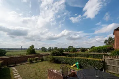 a view from the garden of a house with a toy at 4 Bed in Halesworth oc-mdh in Blythburgh