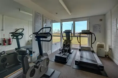a gym with treadmills and machines in a room at 4 Bed in Halesworth oc-mdh in Blythburgh