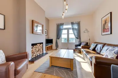 a living room with a couch and a fireplace at 4 Bed in Halesworth oc-mdh in Blythburgh