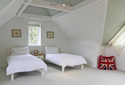 a white room with two beds and a window at 3 Bed in Ufford oc-sfmea in Ufford