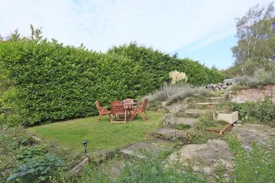 a table and chairs sitting in a garden at 2 Bed in Ufford oc-sfmcu in Ufford