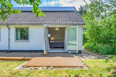 a home with a deck and sliding glass doors at 3 Bed in Westleton oc-egv in Westleton
